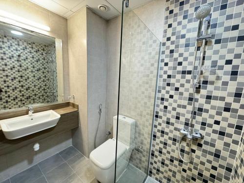 a bathroom with a toilet and a sink and a shower at Studio near Marina - 15mins drive in Dubai