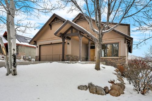 a house with snow in front of it at Wild Horse Meadows Eden Powder Mtn in Wolf Star