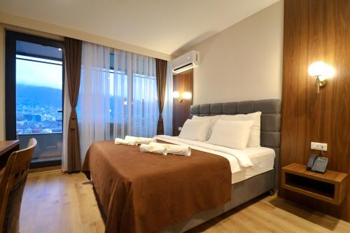 a hotel room with a bed with towels on it at Hotel Semitronix in Peje