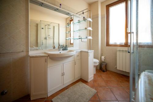 a bathroom with a sink and a toilet at Villino Blu 12 pax villa in Tuscany with private pool in Loro Ciuffenna