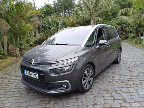 a silver car parked on a cobblestone street at Janela Mar Garden in Lagoa