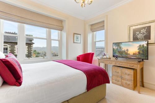 a bedroom with a large bed and a television at The Westbourne in Bowness-on-Windermere