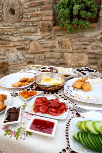 a table with plates of food on it at Hotel Mary's House in Selcuk