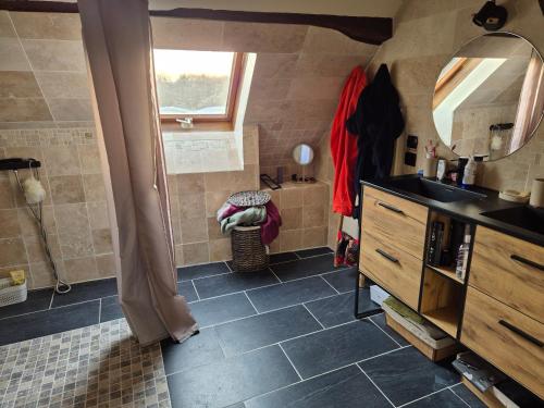 Un baño con ducha, lavabo y espejo. en Maison proche de la gare, en Lisieux