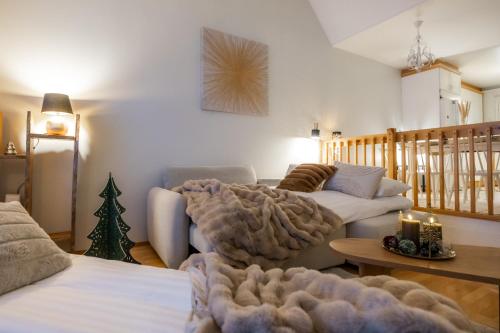 a living room with a couch and a christmas tree at White Elegant Suite by the River in Rovaniemi