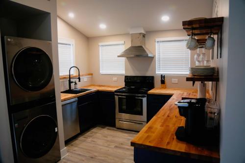 a kitchen with black cabinets and a stove top oven at Cozy Pool & Hot Tub Retreat by Casino in Charles Town