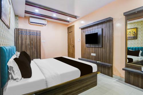 a hotel room with a bed and a television at Hotel O Rameshwar Inn in Prayagraj