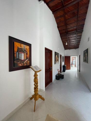 a hallway in a house with a painting on the wall at Hotel Casa Colonial Moñitos in Moñitos