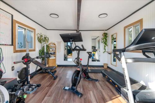 a gym with two treadmills and two exercise bikes at Bohemian Dream Studio Close to LA Stadium SOFI Kia Forum Intuit Dome LA Coliseum in Los Angeles