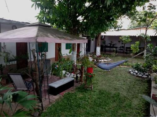 a yard with a hammock and a house at Homestay Tarapoto in San Antonio