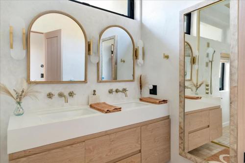 a bathroom with a sink and two mirrors at Bohemian Dream Studio Close to LA Stadium SOFI Kia Forum Intuit Dome LA Coliseum in Los Angeles