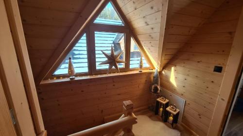 an attic room with a large window and a star at Domki góralskie Sabałecka in Zakopane