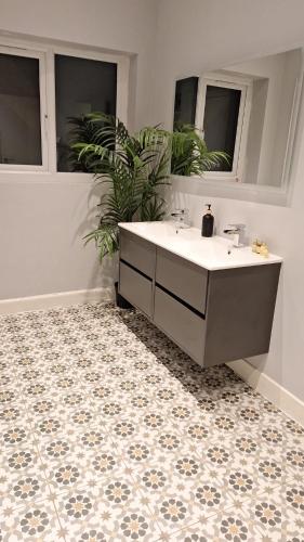 a bathroom with a tub and a sink and a tile floor at Victorian Suites - Spacious 2 Bed Apartment in Southport