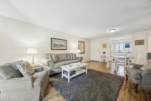 a living room with two couches and a table at 3C Amelia Landings Condo in Fernandina Beach