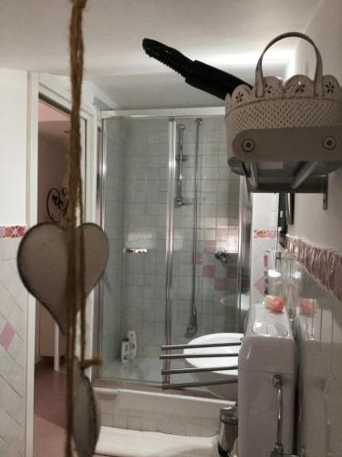 a bathroom with a shower with a glass door at La Roseraie in Battipaglia