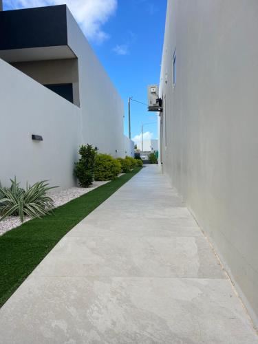 a walkway next to a white building at Mary's Villas Private Pool In Noord in Noord