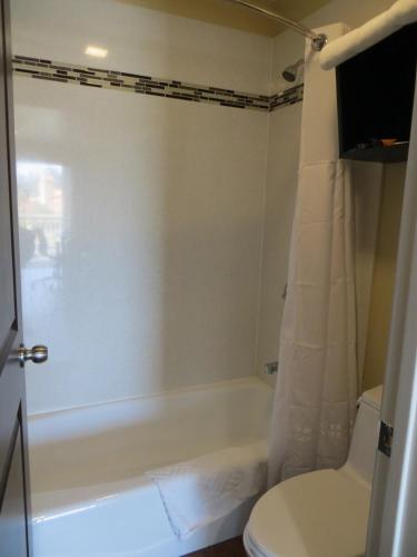 a bathroom with a white tub and a toilet at Muir Woods Lodge in Mill Valley