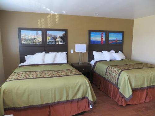 a hotel room with two beds and two windows at Muir Woods Lodge in Mill Valley