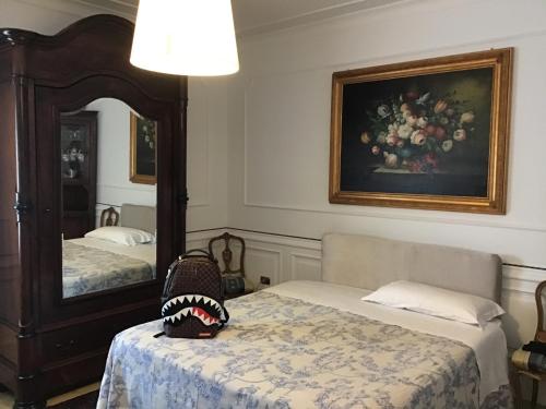 a room with two beds and a mirror with a baseball on the bed at La Roseraie in Battipaglia