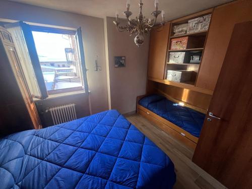 Ένα ή περισσότερα κρεβάτια σε δωμάτιο στο Holiday PratoNevoso - Sci ai piedi