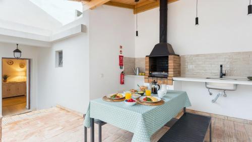 a kitchen with a table with food on it at Casa da Sé Renovated Traditional Townhouse with Courtyard in Silves