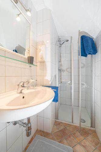 a bathroom with a sink and a shower at Landhaus Dajana in Gaschurn