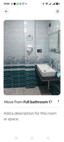 a bathroom with a sink and a mirror at Wind chimes villa in Karsiyang