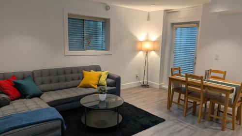 a living room with a couch and a table at A&A Resident in North Vancouver