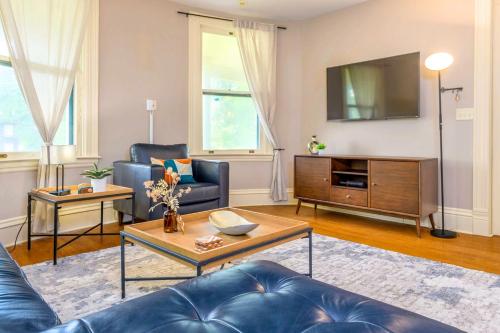 a living room with a couch and a tv at Westcott Suite Apartments in Syracuse