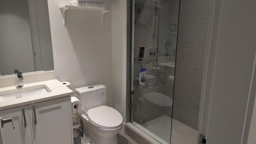 a bathroom with a shower and a toilet and a sink at A&A Resident in North Vancouver