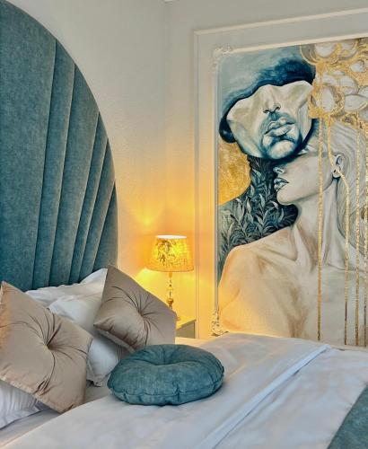a bedroom with a painting on the wall next to a bed at Bridge Apartment & Jacuzzi in Timişoara