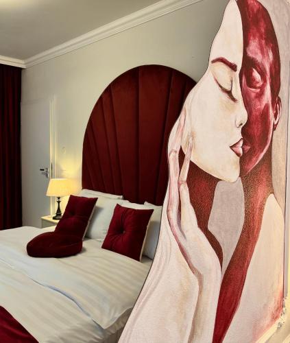 a painting of a woman with her hand to her face at Bridge Apartment & Jacuzzi in Timişoara