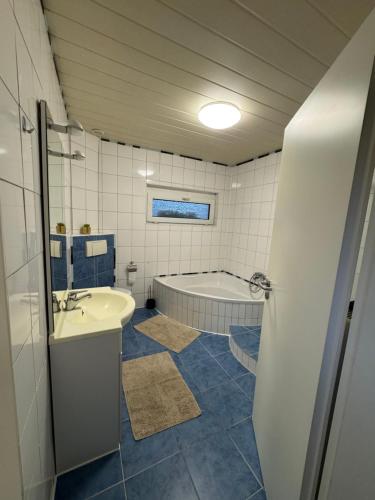 a bathroom with a tub and a toilet and a sink at Haus Teveren in Geilenkirchen