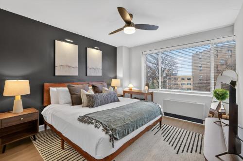 a bedroom with a large bed and a window at Metro Close - Relax Suite with Massage Chair and Parking in Arlington