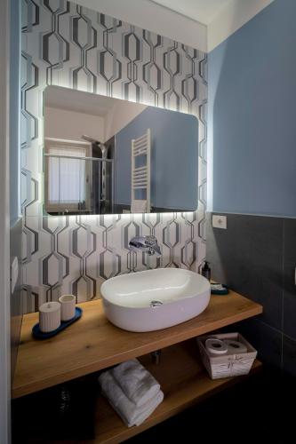 a bathroom with a sink and a mirror at Dimora Fortunato in Bernalda