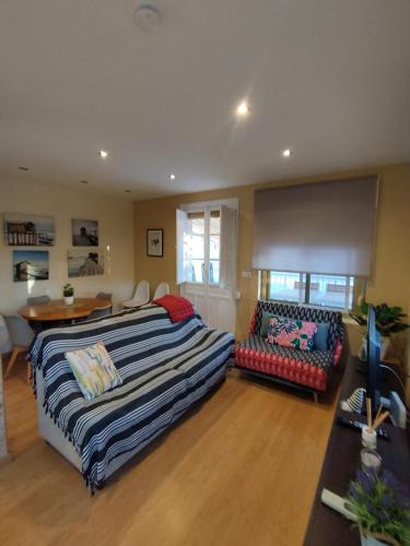 a bedroom with a bed and a couch and a table at sol y arena in Santa Pola