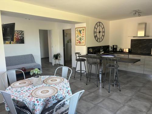 a kitchen and living room with a table and chairs at Chez Suzanne in Corbara