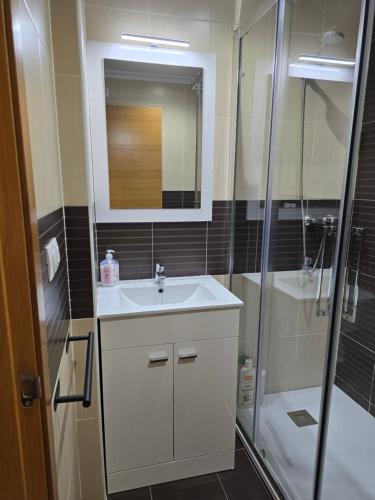a bathroom with a sink and a shower at Ático Paraíso in San Ciprián