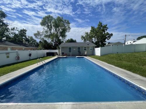 a large blue swimming pool in a yard at Cozy Pool & Hot Tub Retreat by Casino in Charles Town