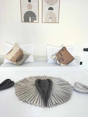 two beds with pillows and a heart on them at Furaha Villa Zanzibar in Kiwengwa