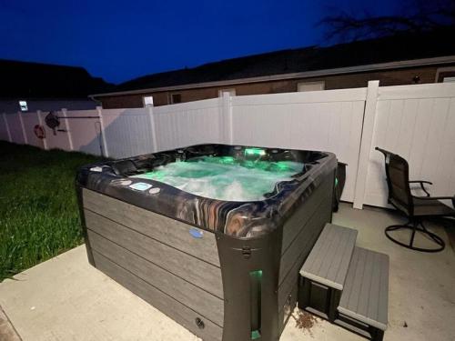 a hot tub in a backyard with a bench at Cozy Pool & Hot Tub Retreat by Casino in Charles Town