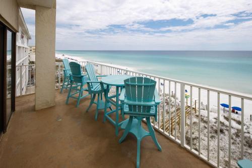 a balcony with chairs and a table and the beach at Gulf Side 601 Pet friendly gulf front condo in Fort Walton Beach