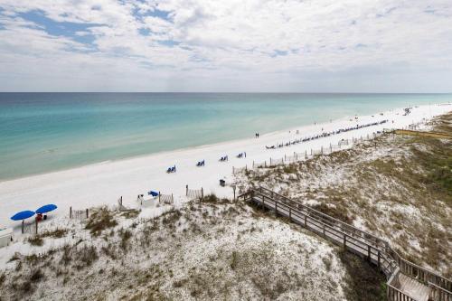 an aerial view of a beach with umbrellas and the ocean at Gulf Side 601 Pet friendly gulf front condo in Fort Walton Beach