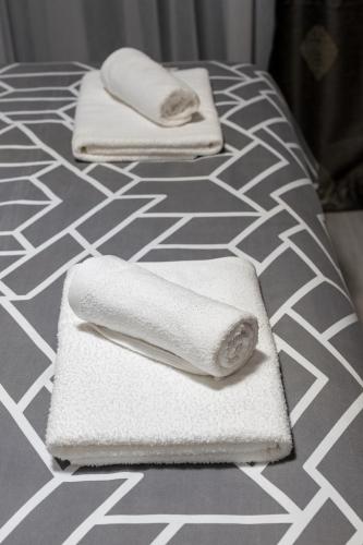 two towels sitting on top of a bed at Apartman Elite Stay Doboj in Doboj