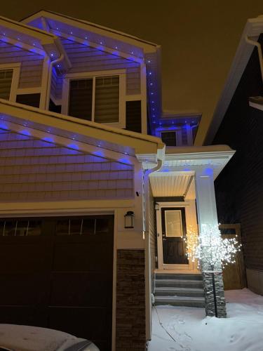 a house with a christmas tree in the front yard at Almost Heaven - Cozy 2BDRM APT near Heritage Park,Spruce Meadows & Banff-SW Calgary in Calgary