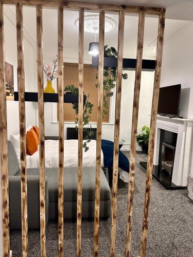 a wooden fence in a room with a bed at House in Tyneside Perfect for Travelers, Groups & Contractors Free Parking in Hebburn-on-Tyne