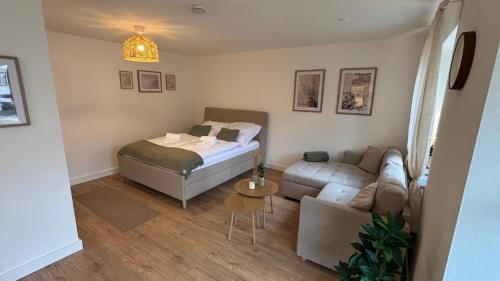 a small room with a bed and a couch at Fewo Eirich in Günzburg