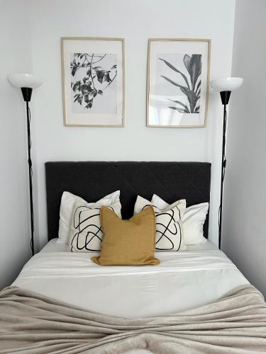 a bedroom with a bed with a black and white headboard at Central Lisbon Apartment in Mouraria in Lisbon