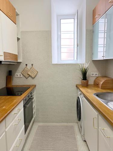 a kitchen with white cabinets and a sink at Central Lisbon Apartment in Mouraria in Lisbon