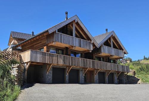 a large wooden house with two garage at The Lodges am Klippitztörl - Chalet in Klippitztorl